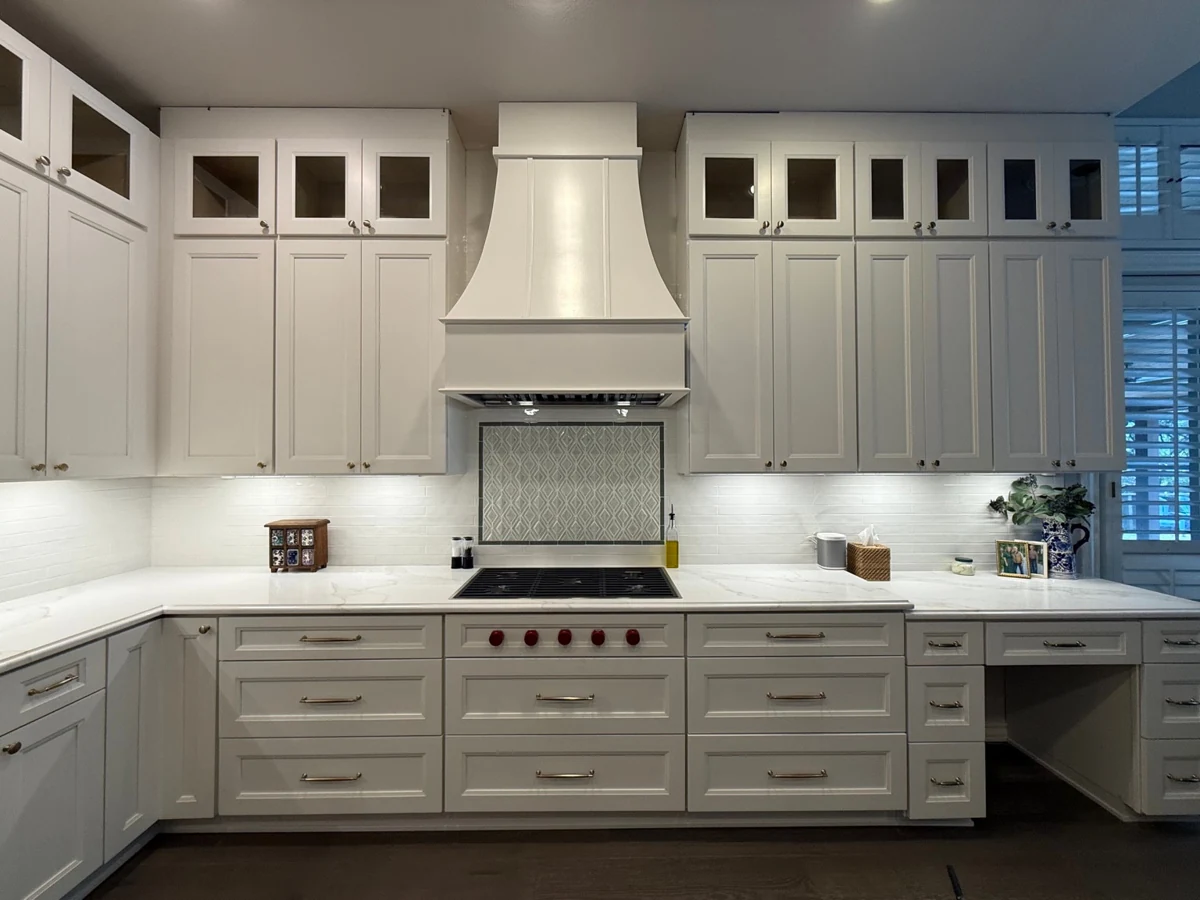 Ivory recessed Shaker cabinetry and Calacatta quartz countertops installed by StoneLux